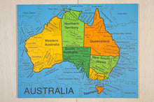Load image into Gallery viewer, Colorful Australia map puzzle on a wooden surface