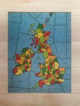 Load image into Gallery viewer, a completed wooden Puzzle showing the Counties of the British isles on a pale wood background.