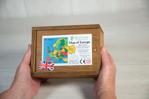Two hands hold a brown wooden box. on the box lid is the label showing the details of the Countries of Europe Jigsaw Puzzle